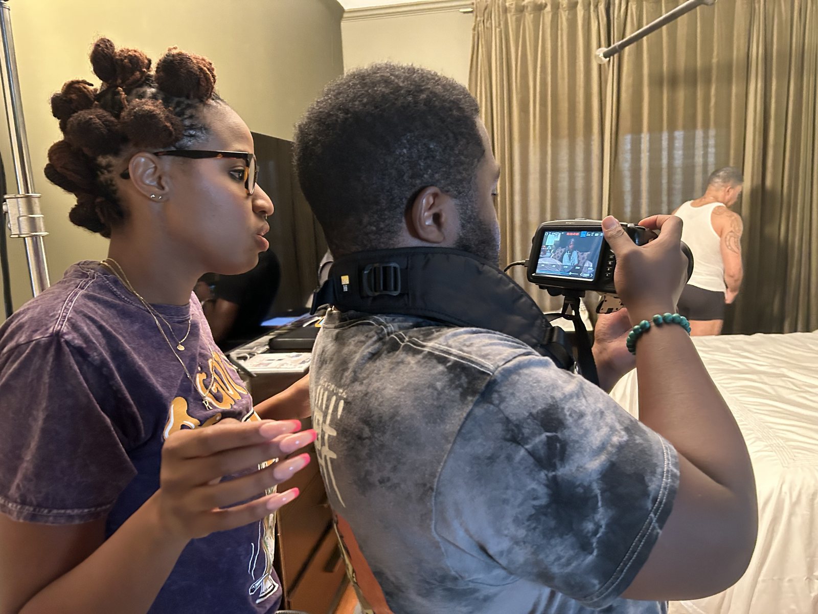 Katiana Farrier reviewing footage on a monitor on set